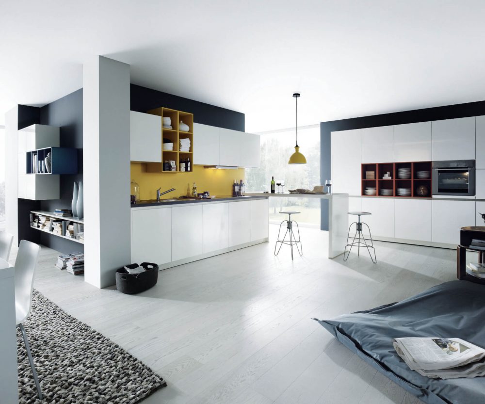 German kitchen in white with coloured open shelving and handleless kitchen units