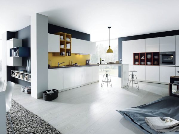 German kitchen in white with coloured open shelving and handleless kitchen units