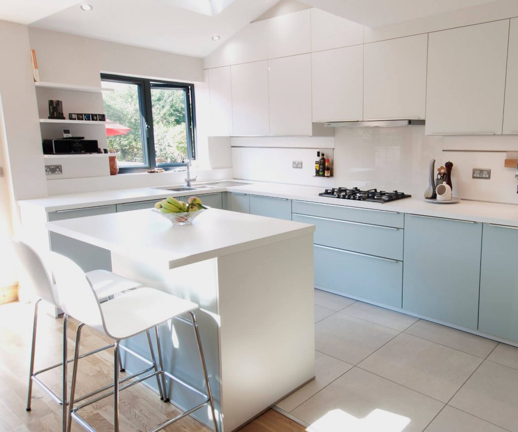 A German kitchen with blue kitchen units and a kitchen island