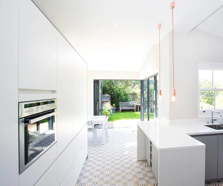 A grey and white German kitchen in a side return extension in London