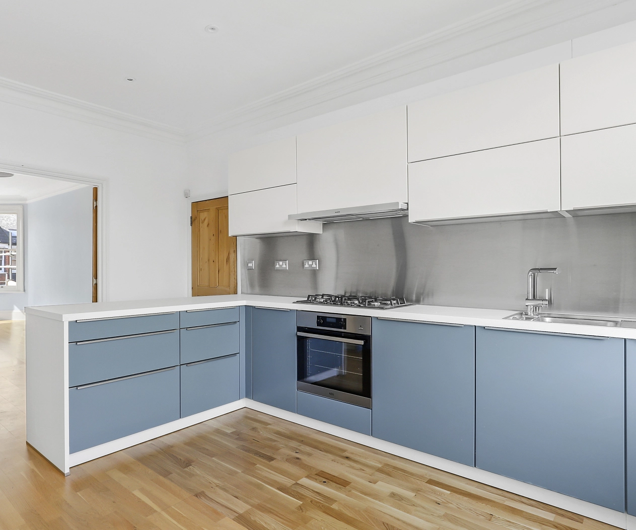German kitchen with blue cupboard fronts and stainless steel handles
