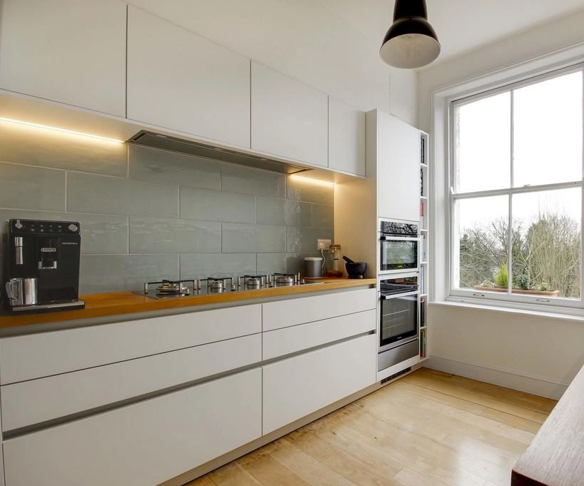 German kitchen with handleless cupboards and wooden worktop