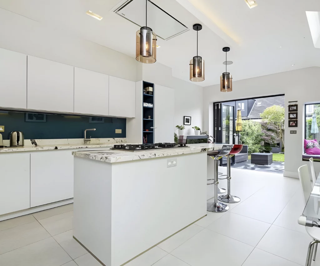White handleless island kitchen in house extension